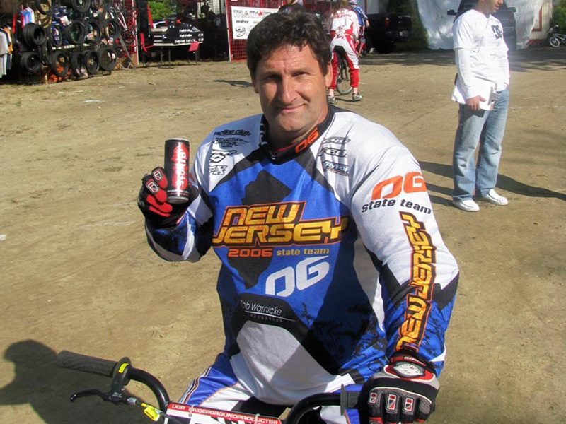 1 BMX rider in full gear holding up can of Bungie Energy Drink